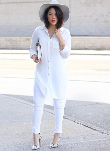 Девушка в белых джинсах и удлиненной белой блузе, шляпа