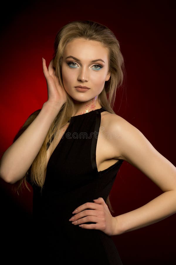 Attractive blonde model with professional makeup wearing black d royalty free stock photos
