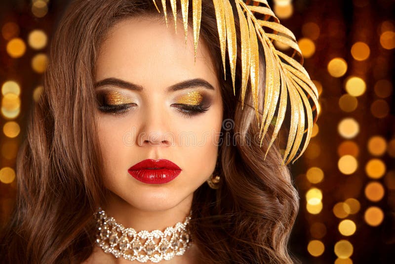 Beauty golden eye makeup. Fashion brunette portrait in gold. Sex. Beauty golden eye makeup. Fashion brunette portrait in gold. elegant woman with red lips royalty free stock photo