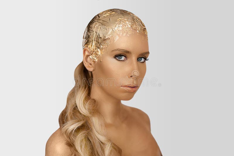 Magic girl portrait with gold skin. Golden creative makeup, close-up portrait in studio shot, color. Magic girl portrait with gold skin. Golden creative makeup royalty free stock images