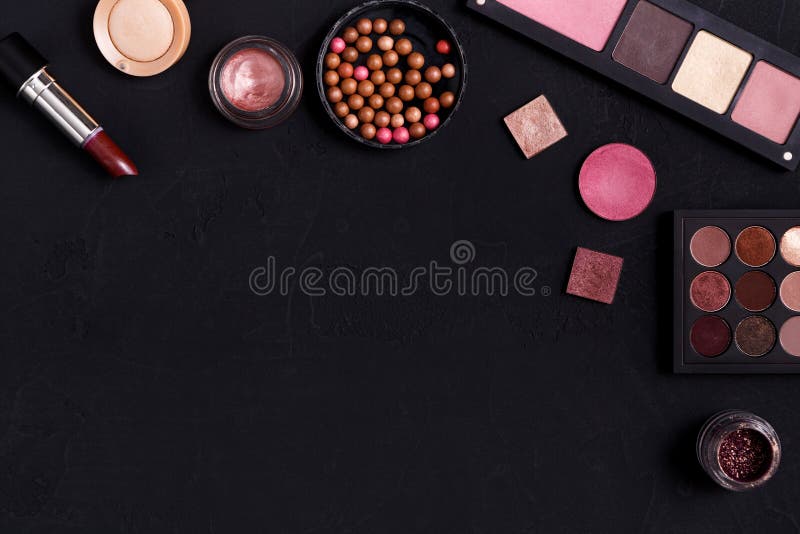 Makeup cosmetics essentials frame black background, copy space. Makeup cosmetics and other essentials frame on black background. Top view, flat lay with copy royalty free stock photos