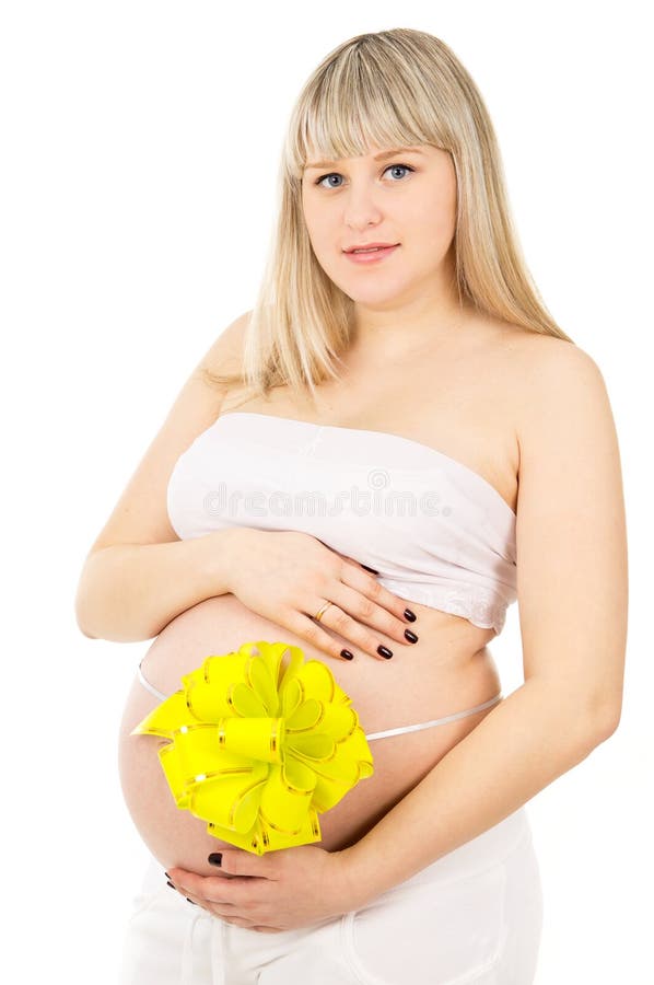Pregnant girl with a bow on her stomach. Isolated royalty free stock images