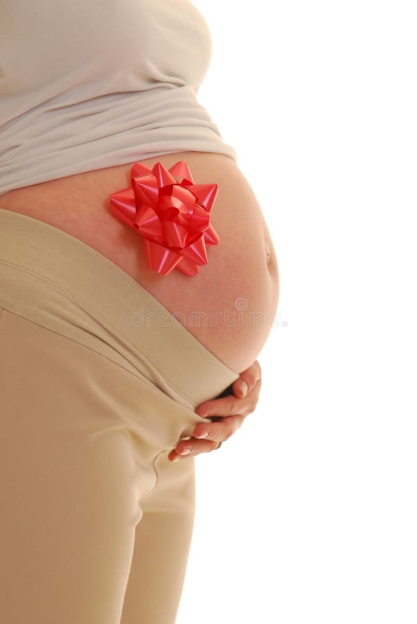 Pregnant woman with red bow on stomach. Pregnant woman profile with red bow on belly royalty free stock photo