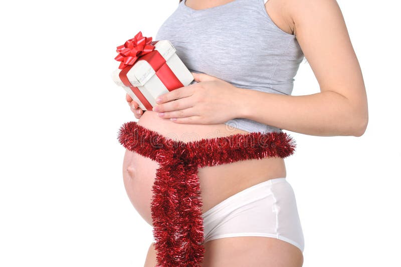Red bow around belly. Of young pregnant woman royalty free stock images