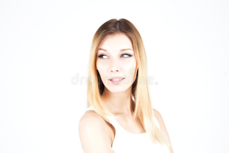 Sensual attractive blonde woman looking away with a smile. Woman with permanent makeup. Arrows on the eyes. Attractive blonde woman looking away with a smile royalty free stock photo