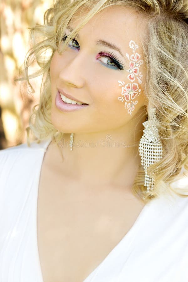 Young beautiful attractive girl blonde with long hair in a Sunny day c a makeup blue eyes in a white dress with a smile o. Young beautiful elegant, attractive stock images