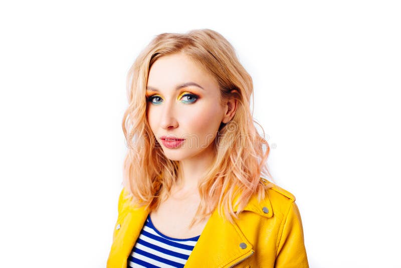 Young blonde girl with an original hairstyle and bright professional makeup stock photo